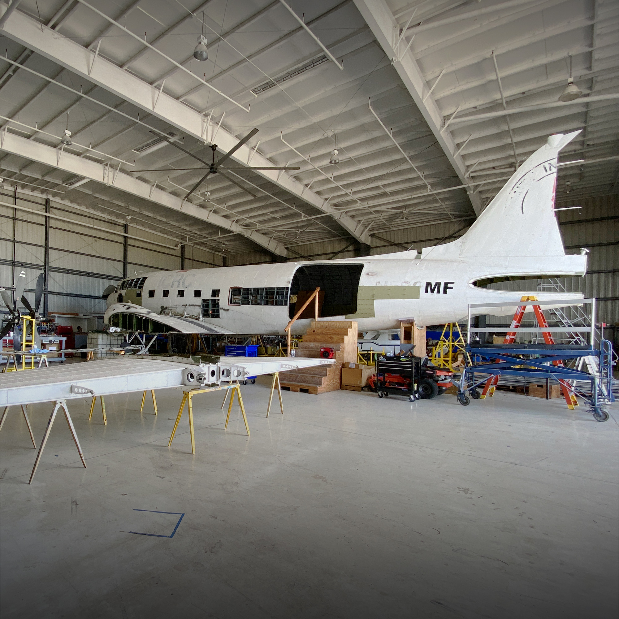 MFI's third airplane sits in the maintenance hangar with a detached horizontal stabilizer.